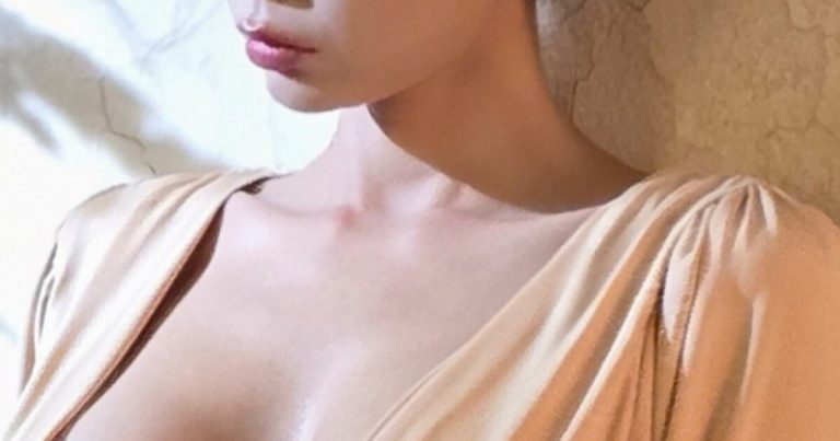 Busty TV Star Flaunts Her Full Figure In A Daring Plunging V-Neck